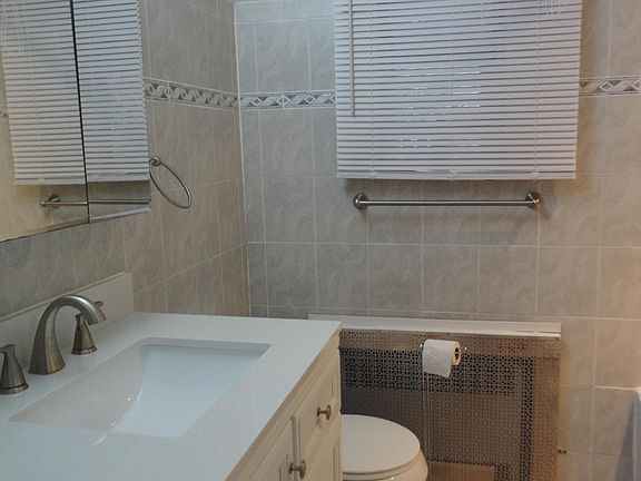 Modern tiled bathroom with linen closet