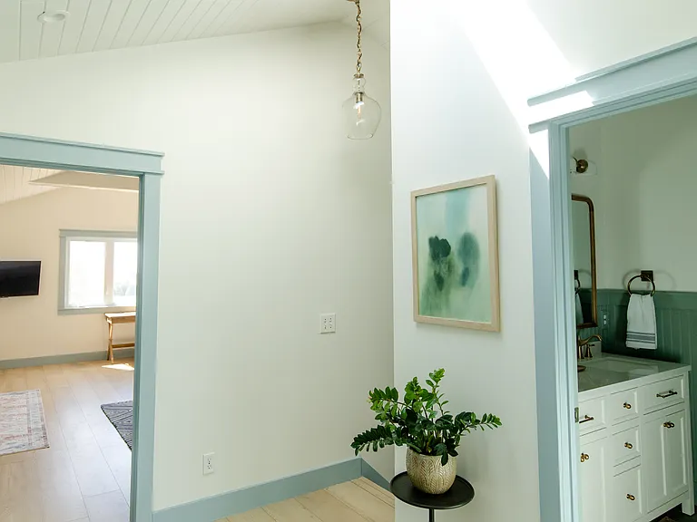 The second floor landing area has a skylight and laundry set up.
