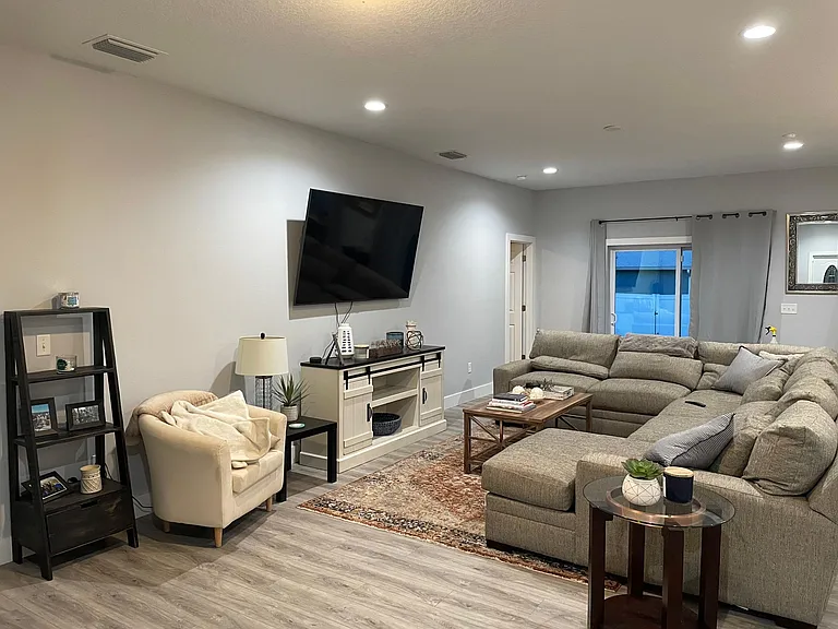 Living room upon entry (staged with furniture)