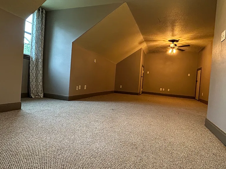 upstairs bedroom suite with bathroom and a very large closet, as well as, walk-in access to attic