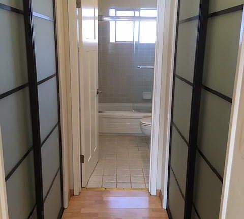 Hallway with closets to bathroom
