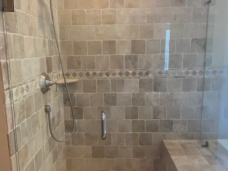 A frameless glass shower in the master bathroom