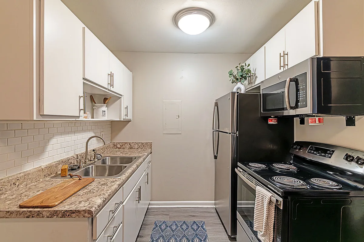 Explore this stylish kitchen, perfectly blending functionality and modern aesthetics. - Condos at Villager