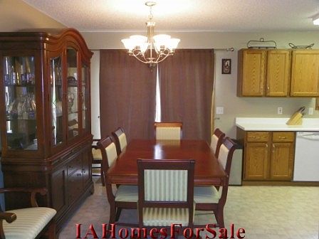 The open dining room has an updated chandelier, and a sliding door to the deck.