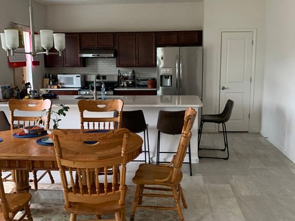 Kitchen with brand new stainless steel appliances.