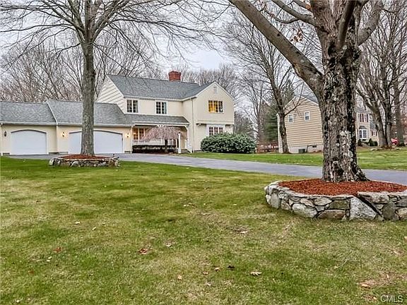 Gorgeous trees beautifully presented surround this lovely home.