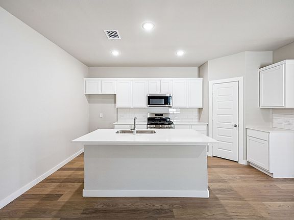 Kitchen in the Willow home plan by Trophy Signature Homes - REPRESENTATIVE PHOTO