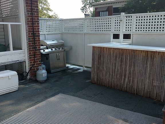 Large outdoor patio with gas grill and bar