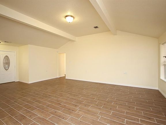 Home offers high ceilings with tile flooring through out the home. Door to the left in the photo is the front door.
