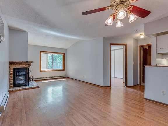 Open and bright layout accented by a wood-burning fireplace and engineered wood flooring.