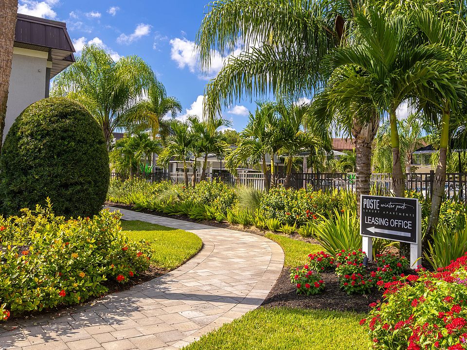 Stroll through the vibrant and lushly landscaped walkway leading to the leasing office. Surrounded by tropical plants and greenery, this inviting path sets the tone for a welcoming and serene community.