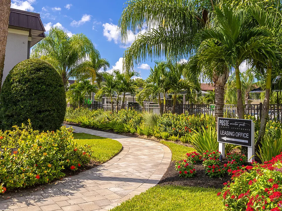 Stroll through the vibrant and lushly landscaped walkway leading to the leasing office. Surrounded by tropical plants and greenery, this inviting path sets the tone for a welcoming and serene community.