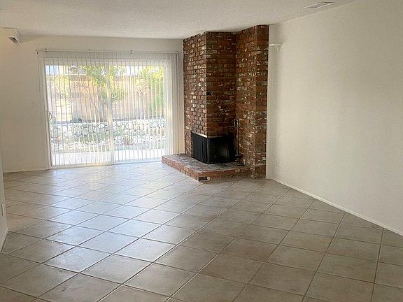Living Room with Fireplace and Slider to Backyard