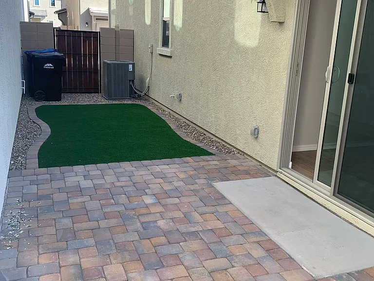 Backyard has a nice paver patio for sitting and BBQ. Also has a nice TURF area.