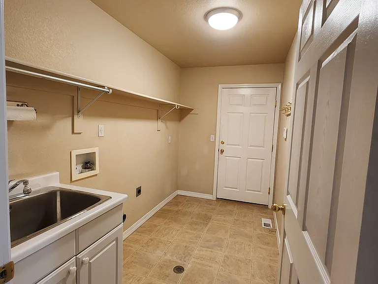 Laundry Room - Door at far end opens to garage.