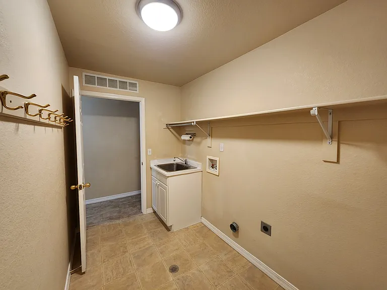 Upstairs Laundry Room / Mud Room of the Hallway to the Bedrooms. Laundry Room / Mud Room goes through to the garage.