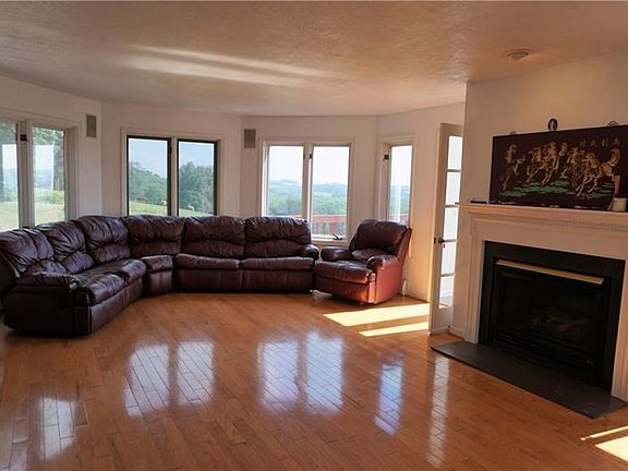 Living room and Dining room with fireplace.  Door leads to Sunroom.  Kitchen is to right of fireplace.  Wonderful open floor pla