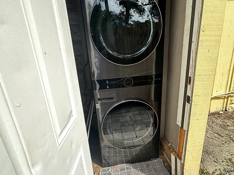 Newer LG stacked washer and dryer.