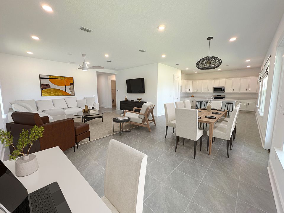The farmtable is located at the open kitchen, with pantry and HUGE island. Indoor-outdoor living. Photo is virtually staged.