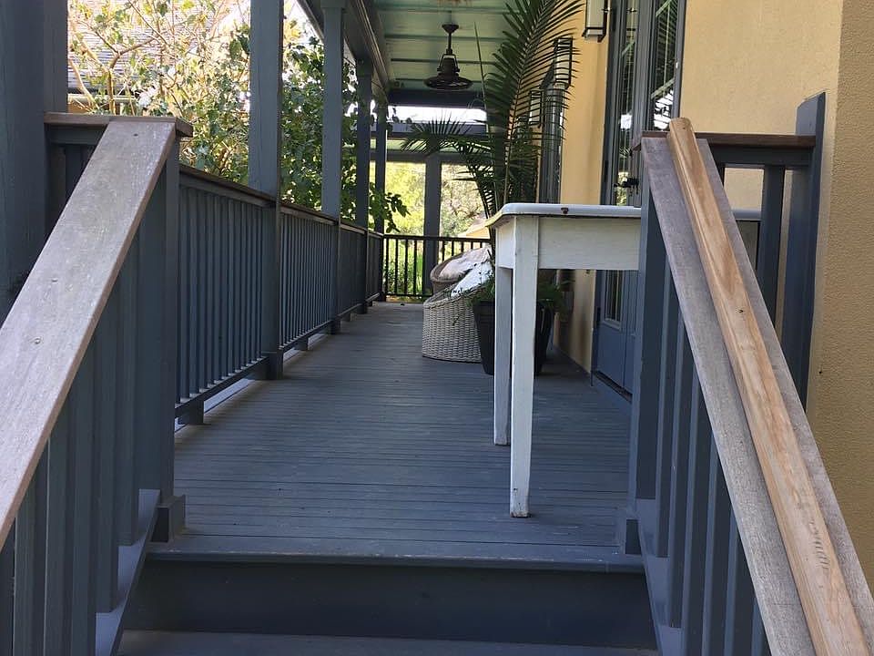 French doors open onto your side porch, extending the length of the cottage, overlooking an adorable swimming pool.