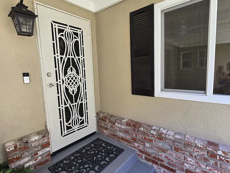 Looking onto the dining room window. Front security door plus Ring Wi Fi camera door bell (tenant to have wifi to operate Ring door bell.
