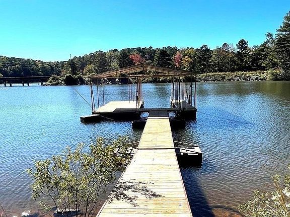 Private dock with water and lights on dock. Lighted path to dock through backyard.