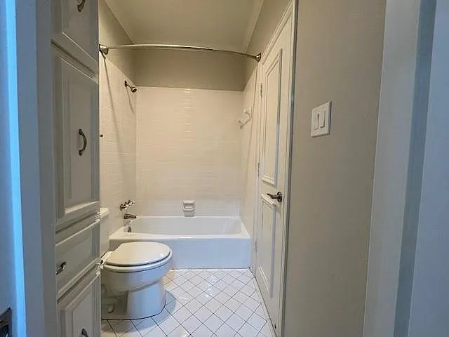 Bathroom featuring light tile patterned floors and tub / shower combination