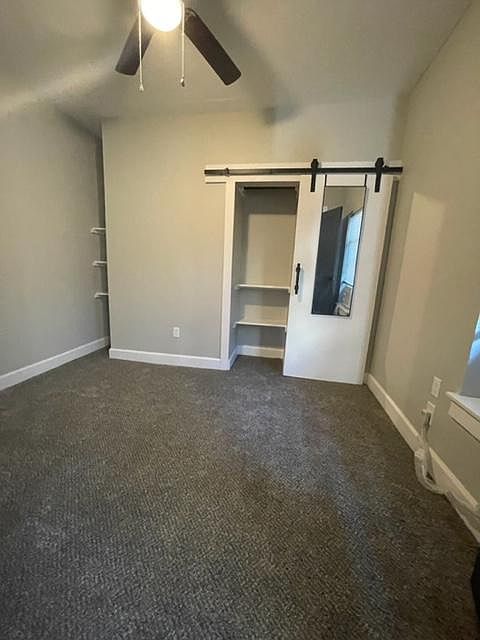 Bedroom with barndoor closet and closet rod