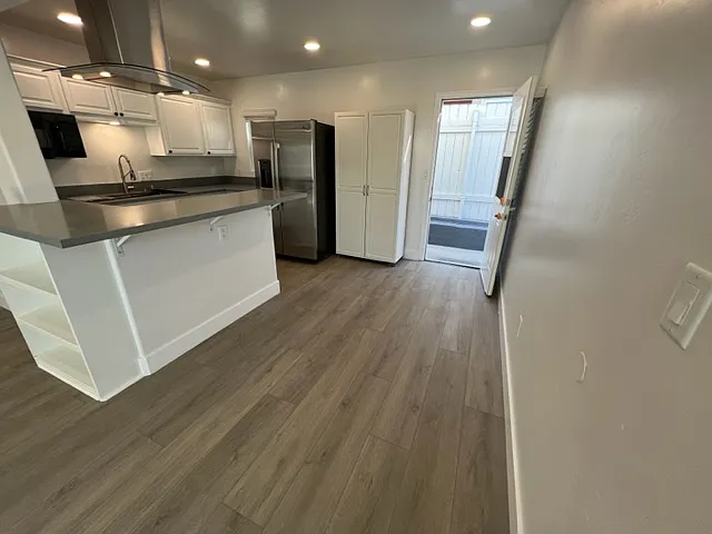 Kitchen bar and dining area with French door opening to the outside as additional access.
