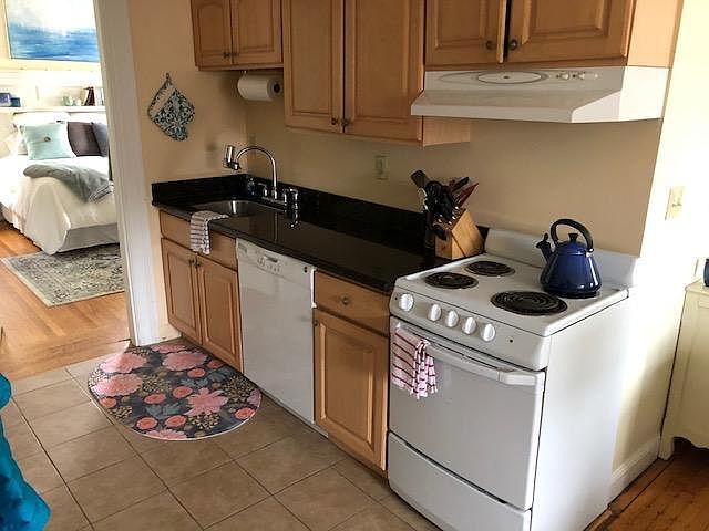 Kitchen. To the left is bedroom to the right is living room.