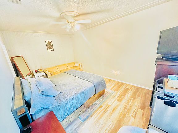 Master bedroom. Beautiful floors and huge window that opens to view the porch.