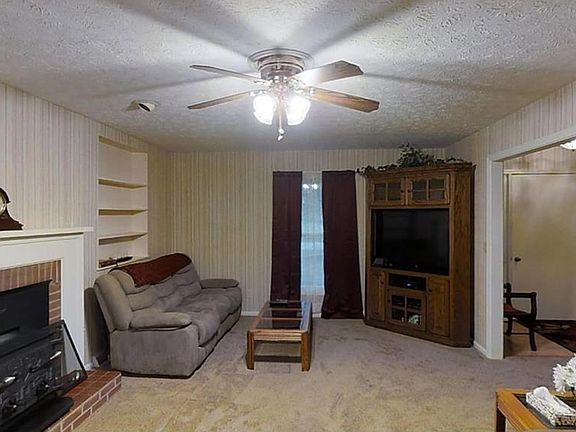 Spacious living room with Franklin Wood stove and access to the front door and back of the house too.