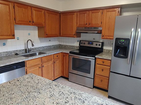 Kitchen with new granite countertops stainless appliances
