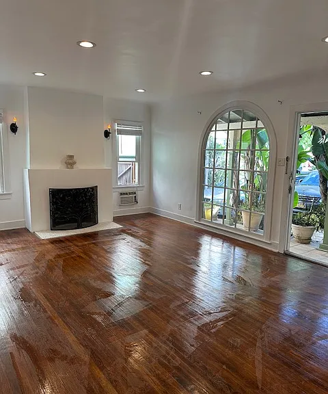 Living room with coved ceilings, fireplace, picture window