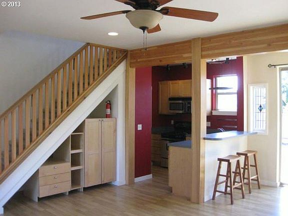 Under stairs pantry and storage make a small kitchen very efficient and usable.