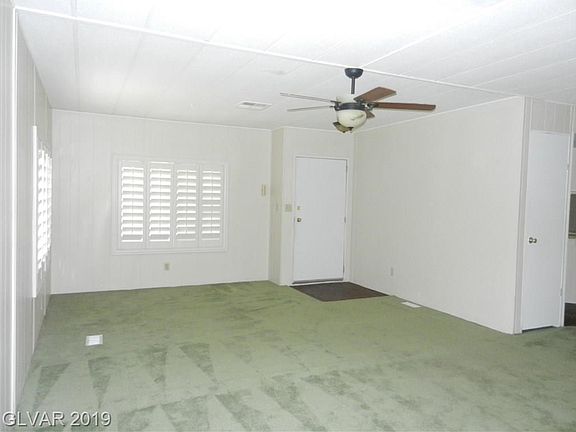 ENTER TO HUGE LIVING ROOM WITH CUSTOM SHUTTERS AND CEILING FAN