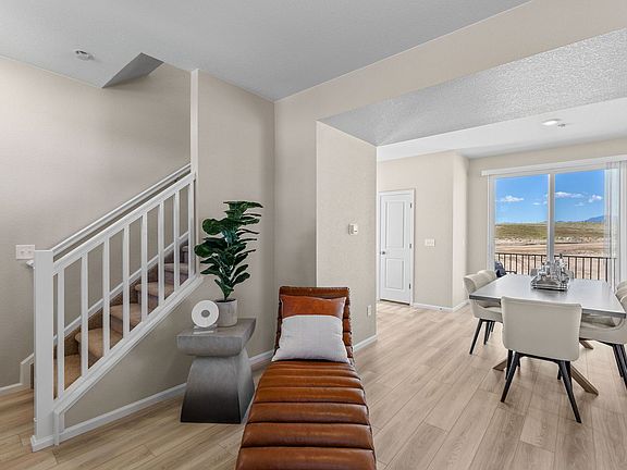 A view of the Stairwell and dining area from Entry