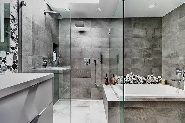Modern primary bath in King ensuite. Dbl sinks, skylight, shower & large tub in enclosed glass wall