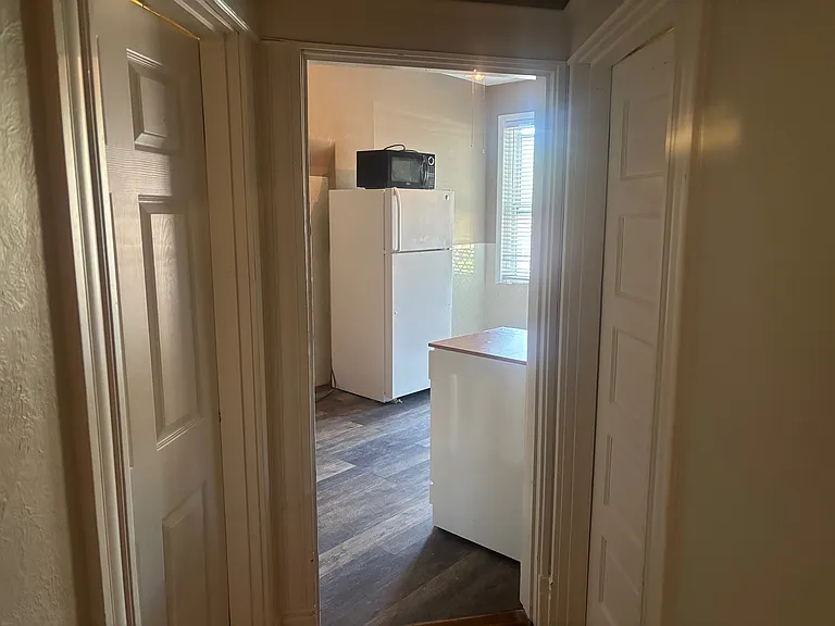 View of Kitchen from hallway with Bedroom (door) on the right and Den/second Bedroom (door) on the left. Bathroom not picture but is on the right.