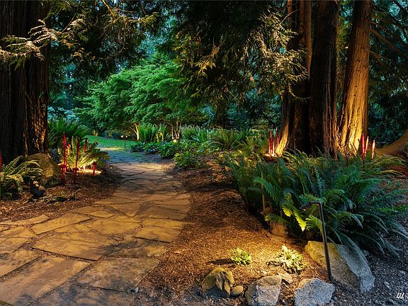 The home has beautiful trails and paths which circumnavigate the yard and are embellished with simply magical lighting!>