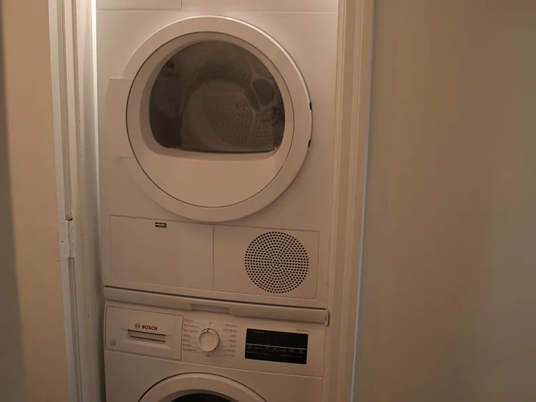 Stackable Bosch Washer and Dryer in dedicated handy closet