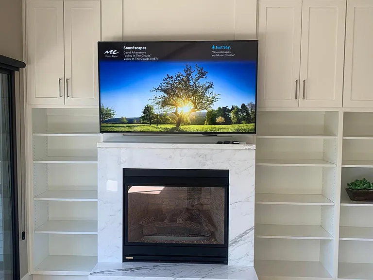 Custom cabinets and bookshelves surround the gas fireplace.