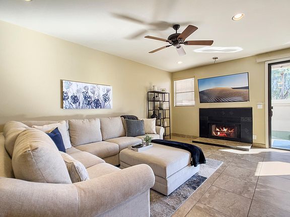 living room with smart TV and comfy sectional with plenty of blankets