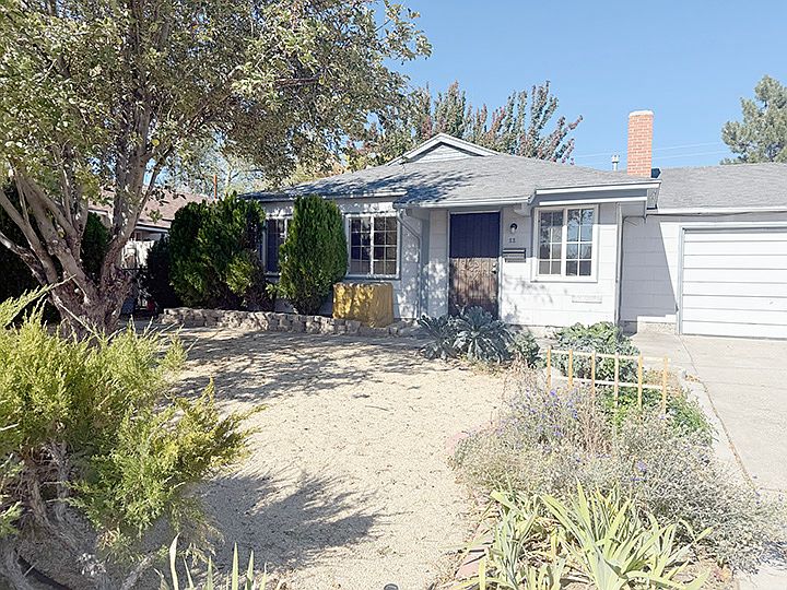 Front yard has mature landscaping including an apple tree