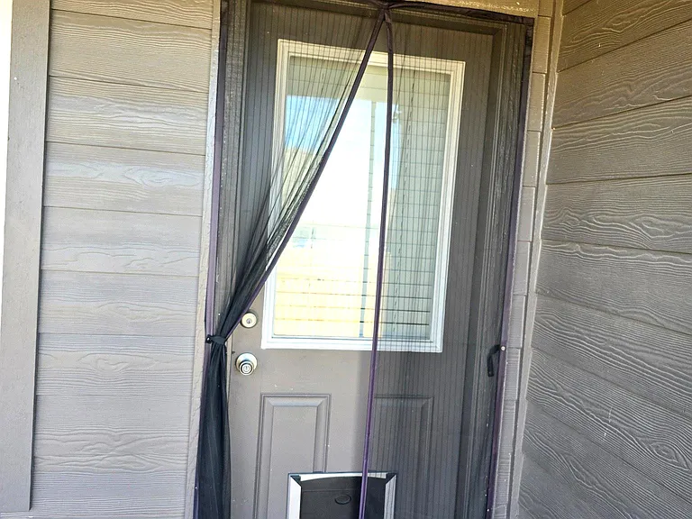 Backyard entry with installed pet door; ideal for pet-friendly living and easy outdoor access.