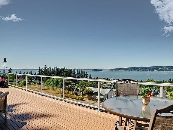 Huge entertaining deck spans width of home & has amazing views, Sunsets, too!