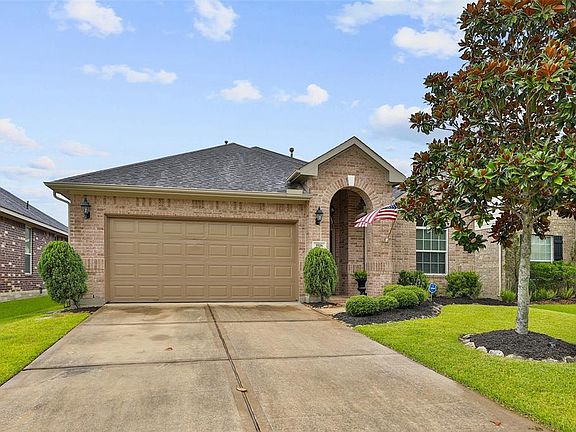 The 2 car garage has shelving and storage