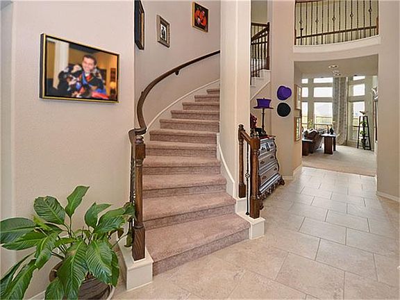 A wrought iron spindled staircase surrounds the foyer leading to the upstairs suite of rooms.