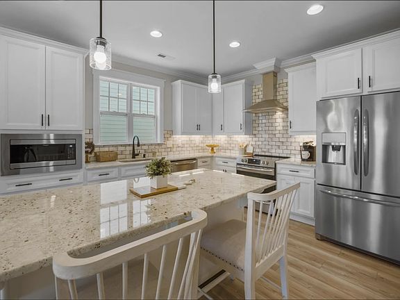Kitchen. Ours has rustic blue subway tiles in a herringbone pattern. White counter tops and upgraded gas stove.