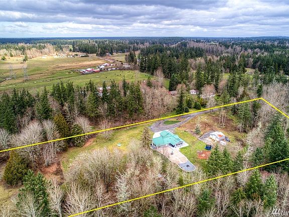 The cross-fenced acreage stretches west and secures a small piece of Lacamas Creek. A stunning country paradise. Well producing hay field also on the western side of the property. 